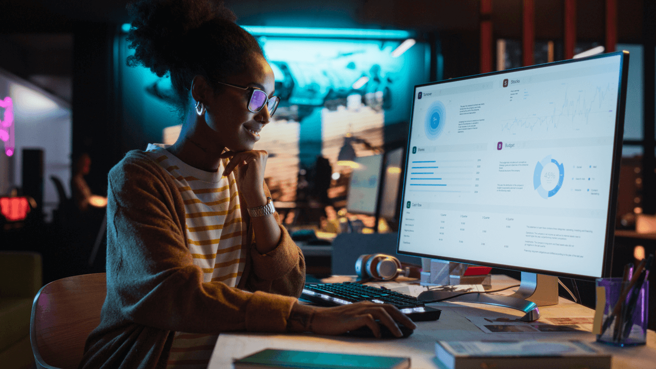 Female worker looking at desktop screen charts